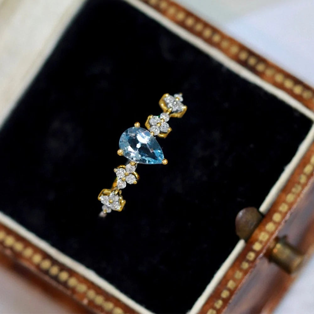 Anillo ajustable de plata con cristal azul para mujer