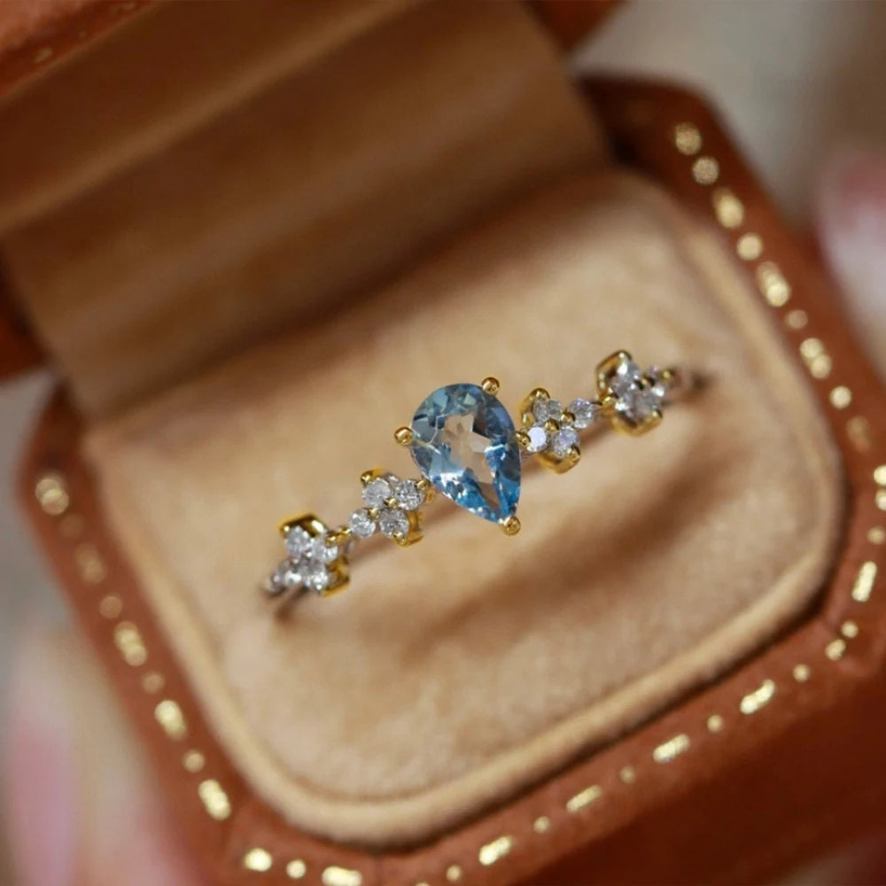 Anillo ajustable de plata con cristal azul para mujer